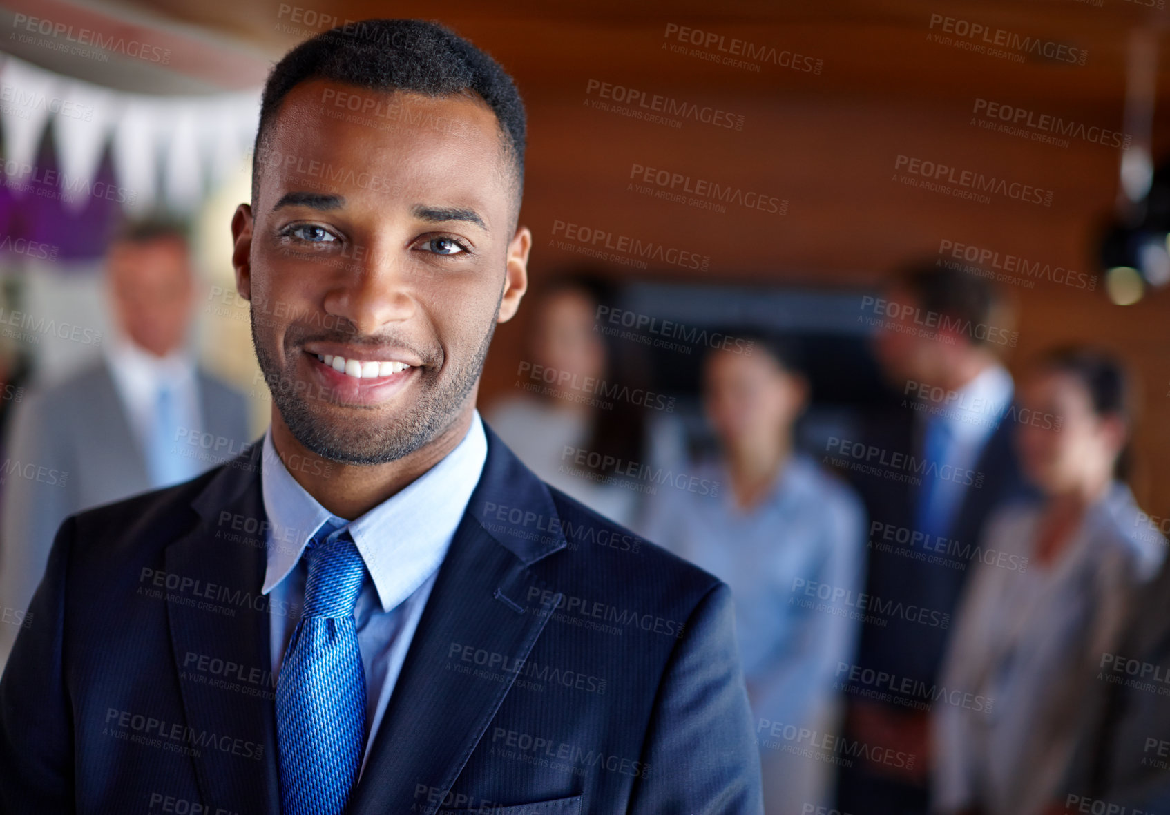 Buy stock photo Shot of a confident businessman standing in front of his team at the office