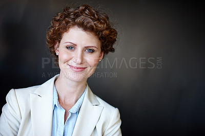 Buy stock photo Studio shot of a confident young businesswoman posing against a dark gray background