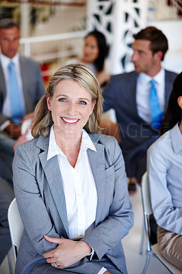 Buy stock photo Portrait of a confident businesswoman sitting in on a presentation at work