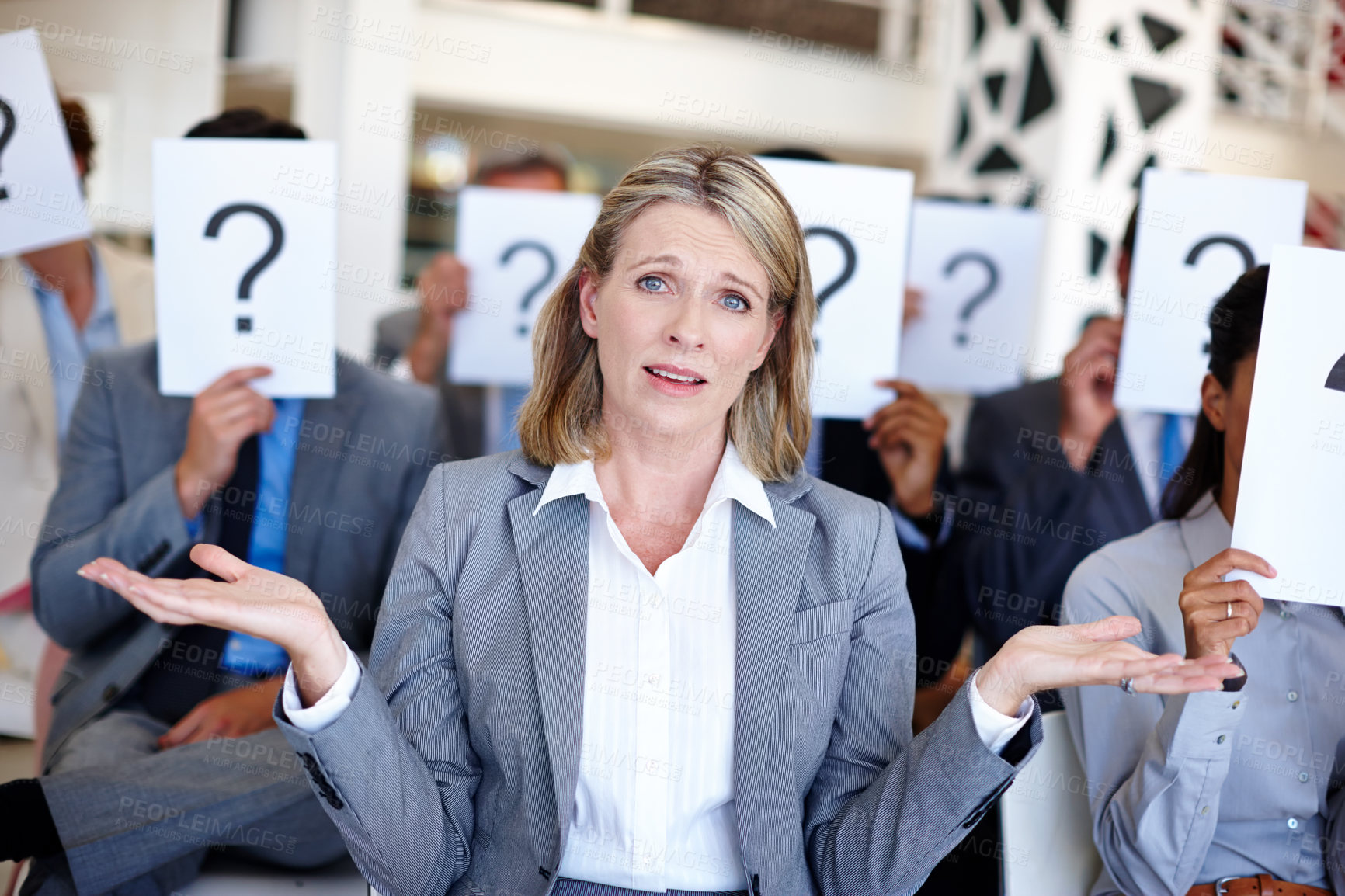 Buy stock photo Conference, confused and woman with question mark in portrait for corporate, problem or uncertain. Employees, audience and sign with emoji at presentation for meeting query, doubt or unsure of answer