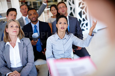 Buy stock photo Shot of a businesswoman asking a question during an office presentation