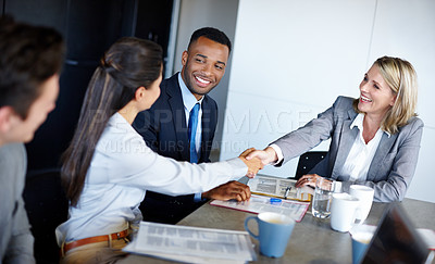 Buy stock photo Shot of professional coworkers shaking hands during a meeting in the office