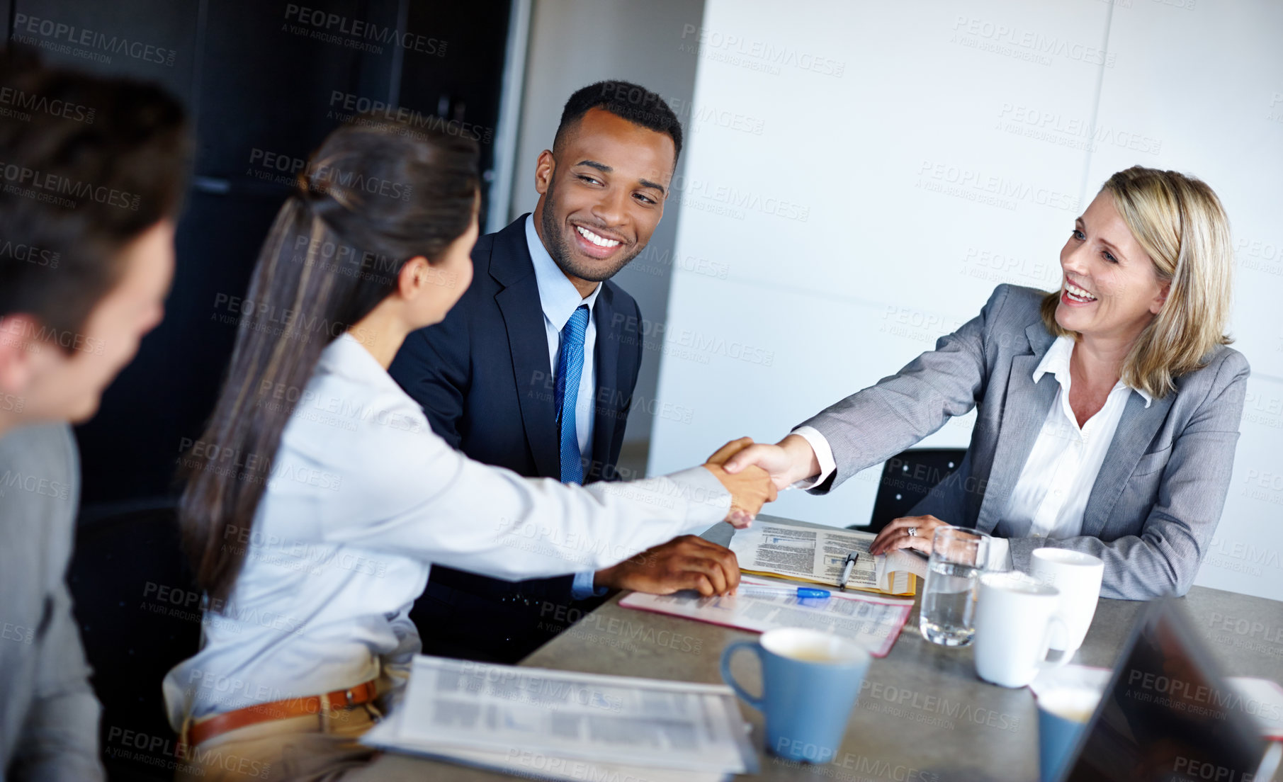 Buy stock photo Shot of professional coworkers shaking hands during a meeting in the office