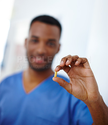 Buy stock photo Closeup shot of a doctor holding a capsule in his hand