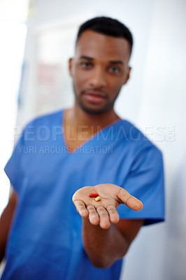 Buy stock photo Closeup shot of a doctor holding two capsules in his hand