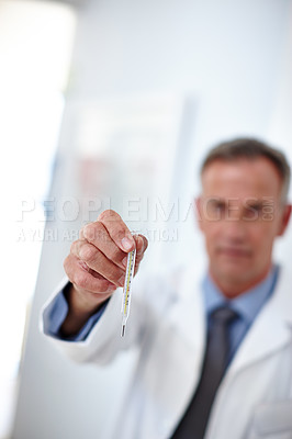 Buy stock photo Closeup shot of a doctor holding a thermometer in his hand