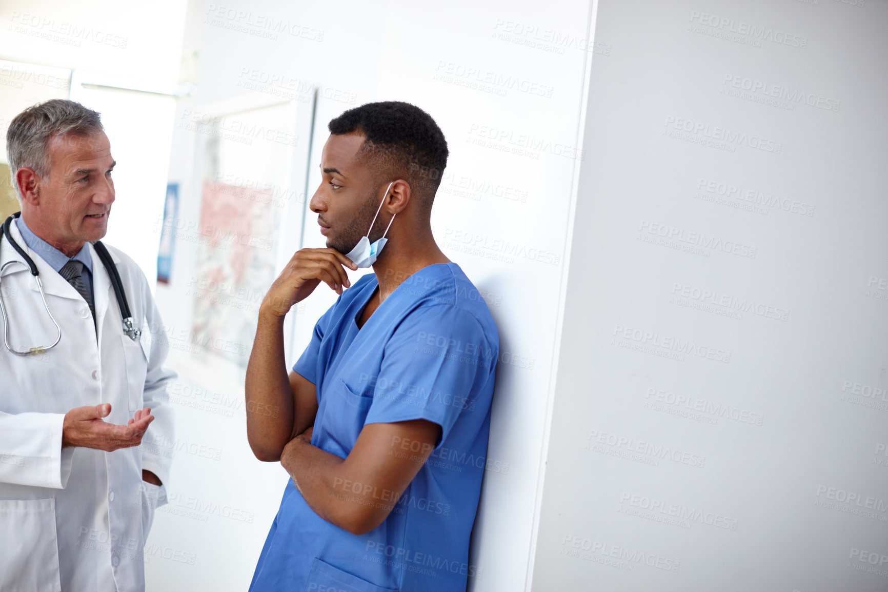 Buy stock photo Shot of a doctor and a surgeon having a difficult conversation 