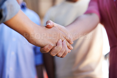 Buy stock photo Cropped shot of two people shaking hands