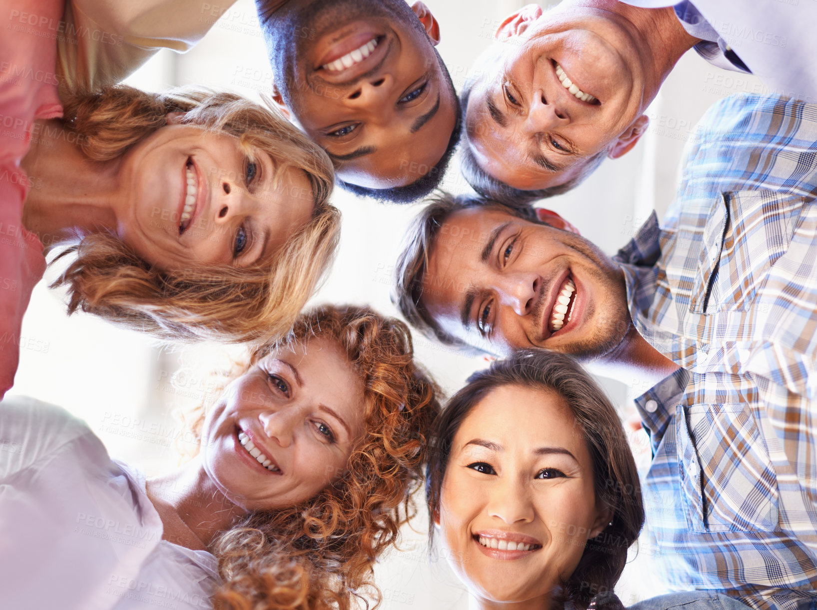 Buy stock photo Cropped low angle shot of a business team standing in a circle