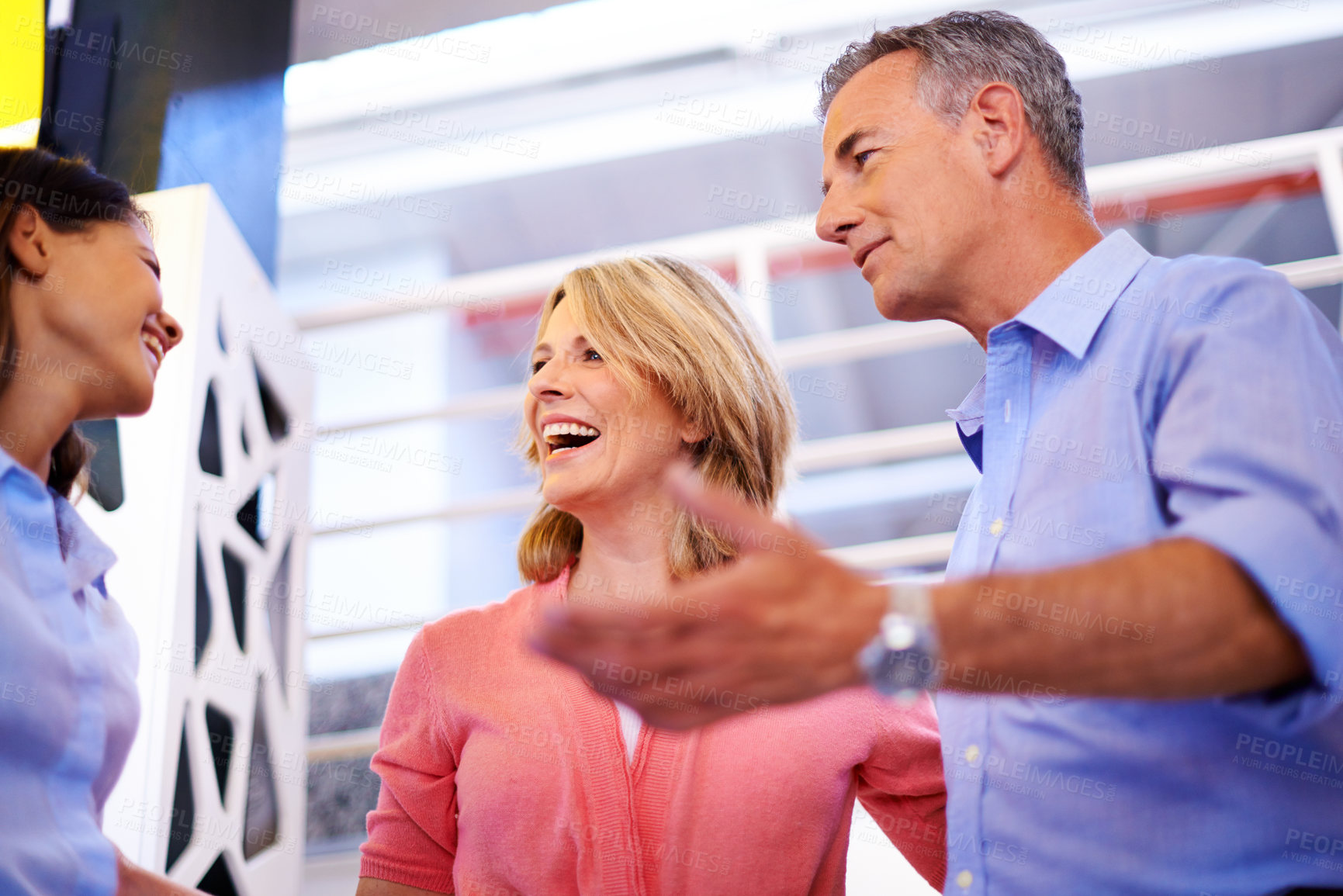 Buy stock photo Shot of business colleagues having a discussion in an informal work environment