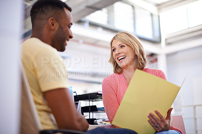 Buy stock photo Shot of two business colleagues having a discussion about work