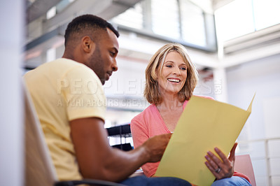 Buy stock photo Shot of two business colleagues having a discussion about work
