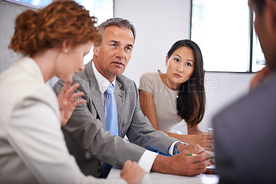 Buy stock photo Shot of a group of businesspeople in a meeting