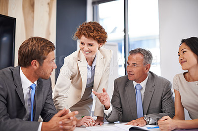 Buy stock photo Shot of a group of businesspeople in a boardroom meeting
