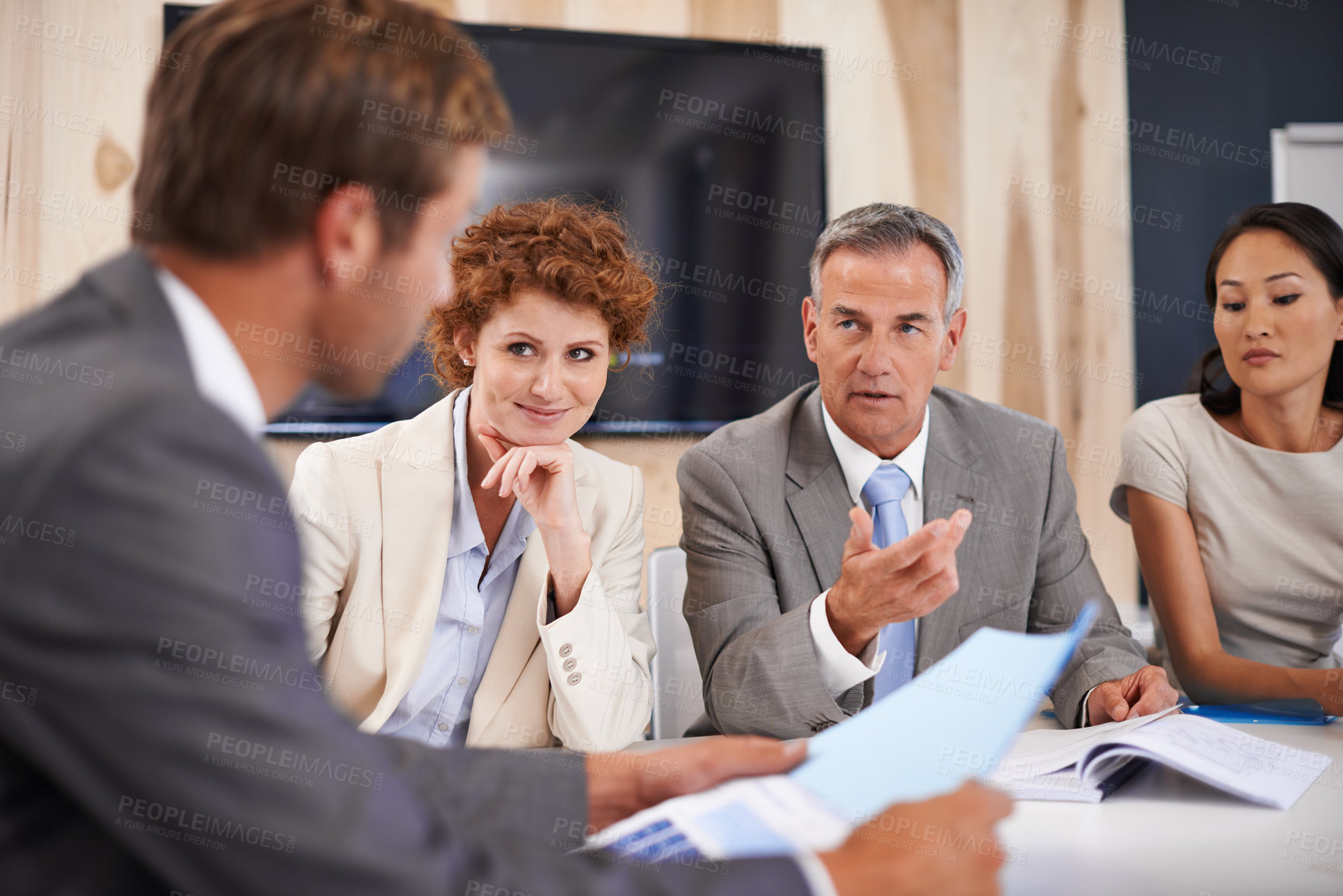 Buy stock photo Shot of a group of businesspeople in a boardroom meeting