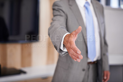 Buy stock photo Cropped shot of a businessman extending his arm towards the camera for a handshake