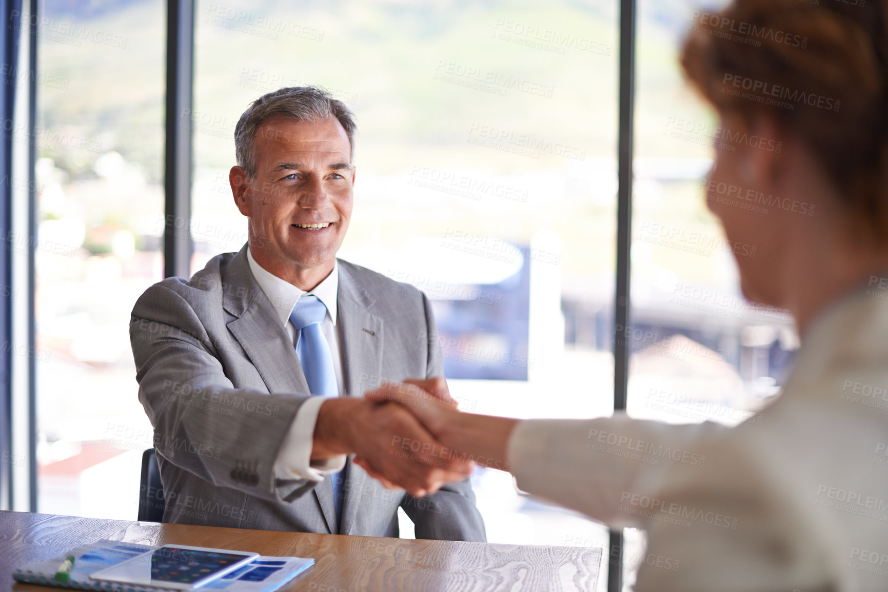 Buy stock photo Shot of a businessman shaking the hand of a colleague in the boardroom