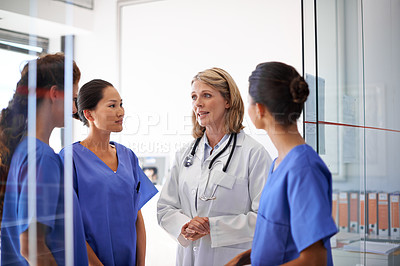 Buy stock photo Team, discussion and woman doctor or medical professionals on healthcare planning or wellness analysis in hospital. Leader, meeting and mature nurse or student staff for collaboration and clinic