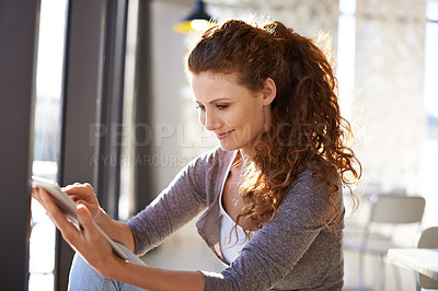 Buy stock photo Woman, tablet and reading by window at cafe with smile, scroll and check notification on social media. Person, happy and digital touchscreen with application, chat and start morning at coffee shop