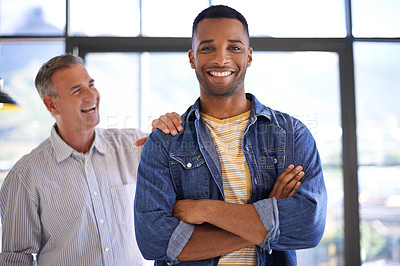 Buy stock photo Shot of a young man receiving a pat on the shoulder from a colleague