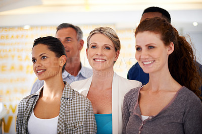 Buy stock photo Shot of a diverse group of casually-dressed employees standing together indoors