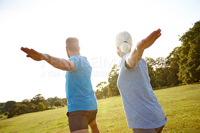 Buy stock photo Couple, stretching and fitness with yoga in nature for exercise, balance and mobility at park. Back, mature people and warrior pose on grass for arm workout, holistic wellness or posture with pilates