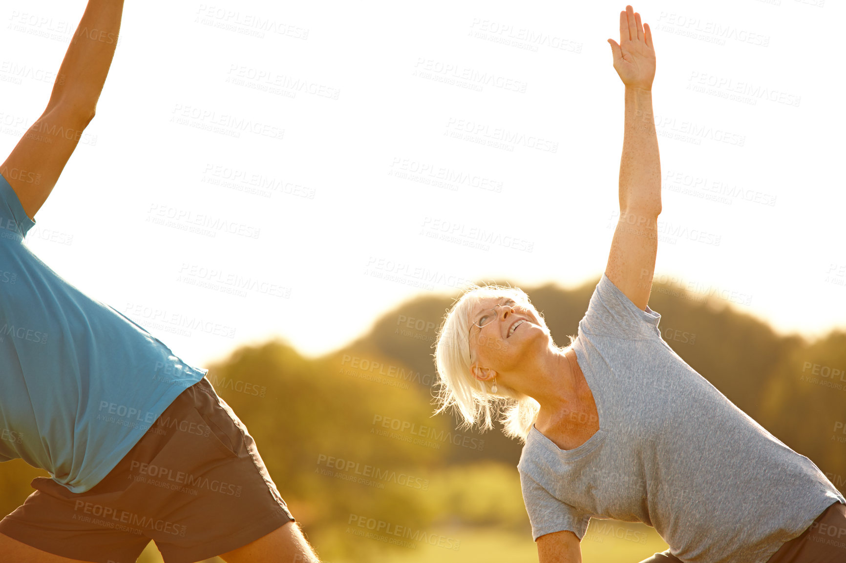 Buy stock photo Pilates, class and senior woman with stretching in park for exercise, balance and mobility in nature. Outdoor, people and together on field for arm workout, holistic wellness and mockup with yoga