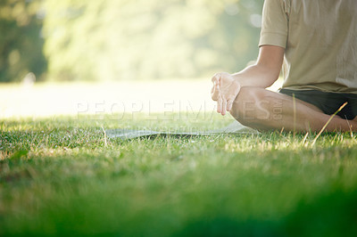 Buy stock photo Cropped shot of a man sitting in the lotus position on the grass