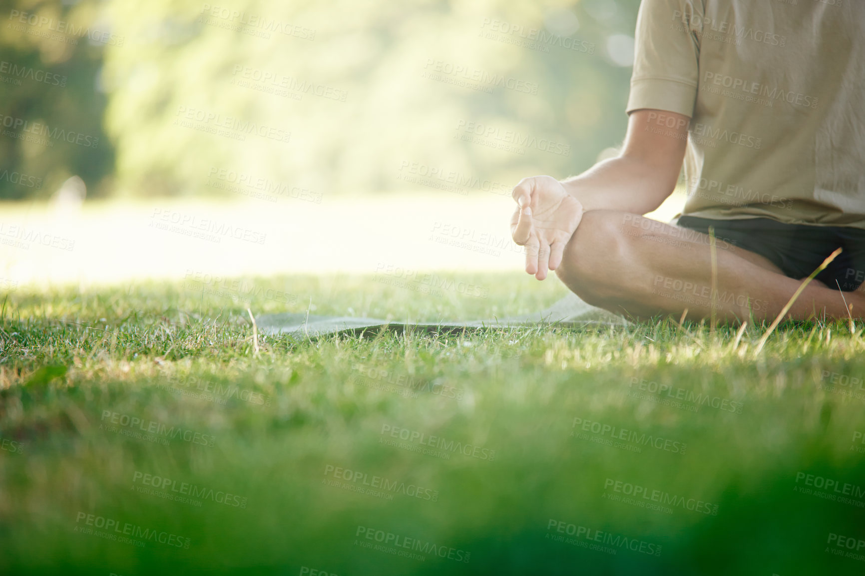 Buy stock photo Cropped shot of a man sitting in the lotus position on the grass