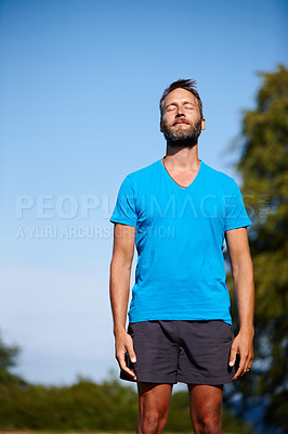 Buy stock photo Nature, relax and man breathing for meditation, wellness and holistic health with calm soul. Namaste, yogi and zen person in park for mindfulness, chakra balance or peace with awareness or fresh air