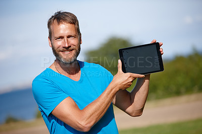 Buy stock photo Happy man, portrait and nature with tablet screen for advertising, marketing or outdoor app. Mature, male person or yogi with smile or technology display for tutorial, health tips or mockup at park