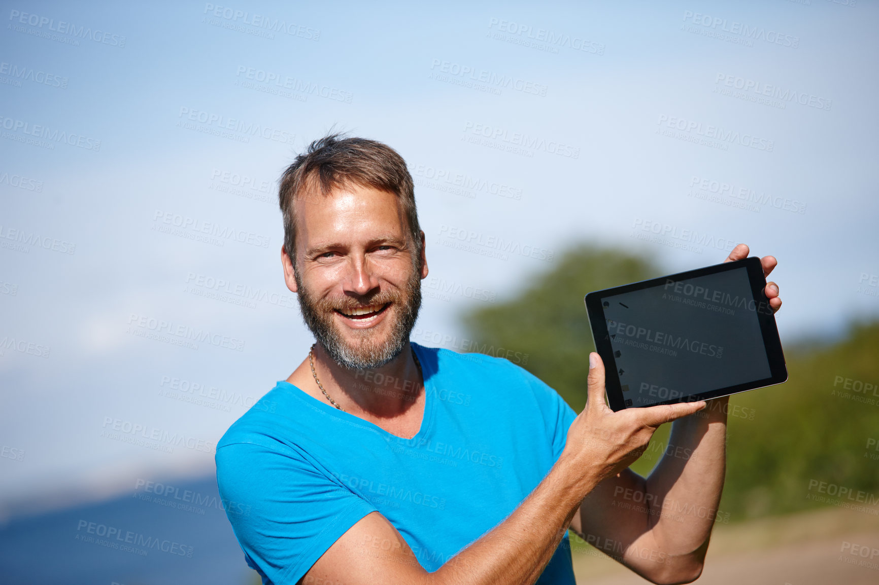 Buy stock photo Happy man, portrait and nature with tablet screen for marketing, advertising or outdoor app. Mature, male person or yogi with smile or technology display for tutorial, health tips or mockup at park