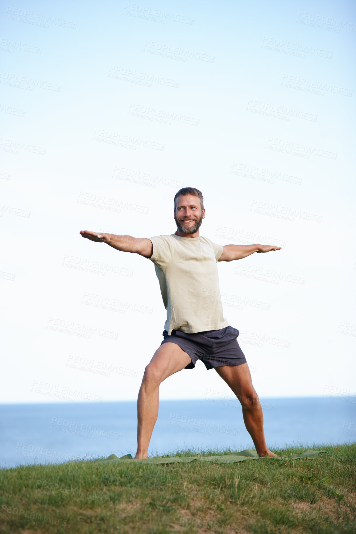 Buy stock photo Happy, man and stretching in nature with yoga for exercise, balance and mobility on grass. Pilates, mature yogi and warrior pose on lawn for workout, holistic wellness and posture with fitness mockup