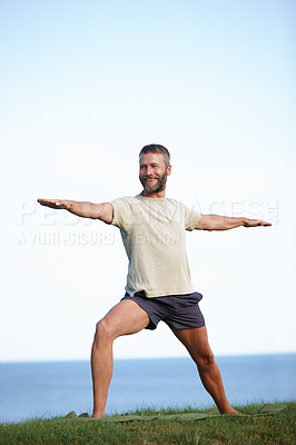 Buy stock photo Smile, man and stretching in nature with yoga for exercise, balance and mobility on grass. Pilates, mature yogi and warrior pose on lawn for workout, holistic wellness and posture with fitness mockup