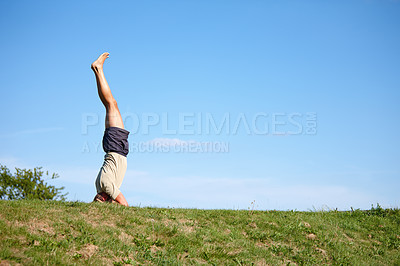 Buy stock photo Man, blue sky and handstand with grass field for holistic workout, mindfulness or exercise in nature. Male person, yogi or active with balance on lawn with mockup space for health and wellness in air