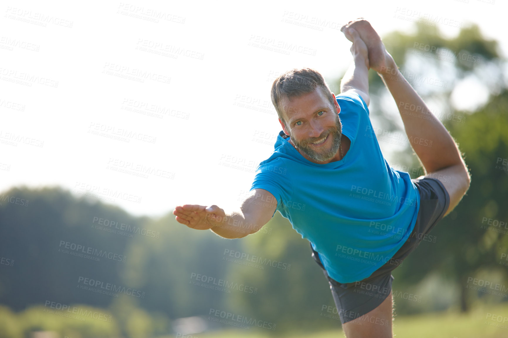 Buy stock photo Cropped shot of a handsome mature man doing yoga outdoors