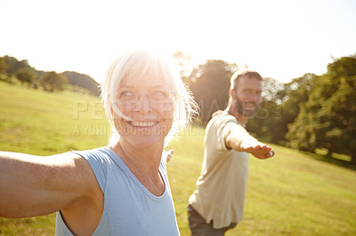 Buy stock photo Shot of a happy mature couple doing yoga together outdoors