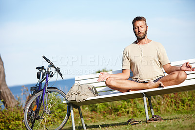 Buy stock photo Yoga, lotus and man with meditation music at park for breath exercise, mindfulness or holistic fitness. Zen, mature yogi and earphones for health, body wellness or listen to audio for peace on bench