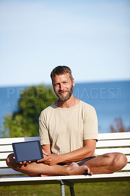 Buy stock photo Happy man, portrait and bench with tablet screen for marketing, advertising or outdoor app. Mature, male person or yogi with smile or technology display for tutorial, health tips or mockup at beach