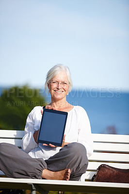 Buy stock photo Mature woman, portrait or bench with tablet screen for advertising, marketing or outdoor app. Senior, female person or smile with technology display for tutorial, health tips or mockup at beach