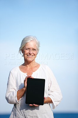 Buy stock photo Senior woman, portrait and advertising with tablet screen for marketing or outdoor app. Mature, female person or smile with technology display for tutorial, health tips or mockup space at beach