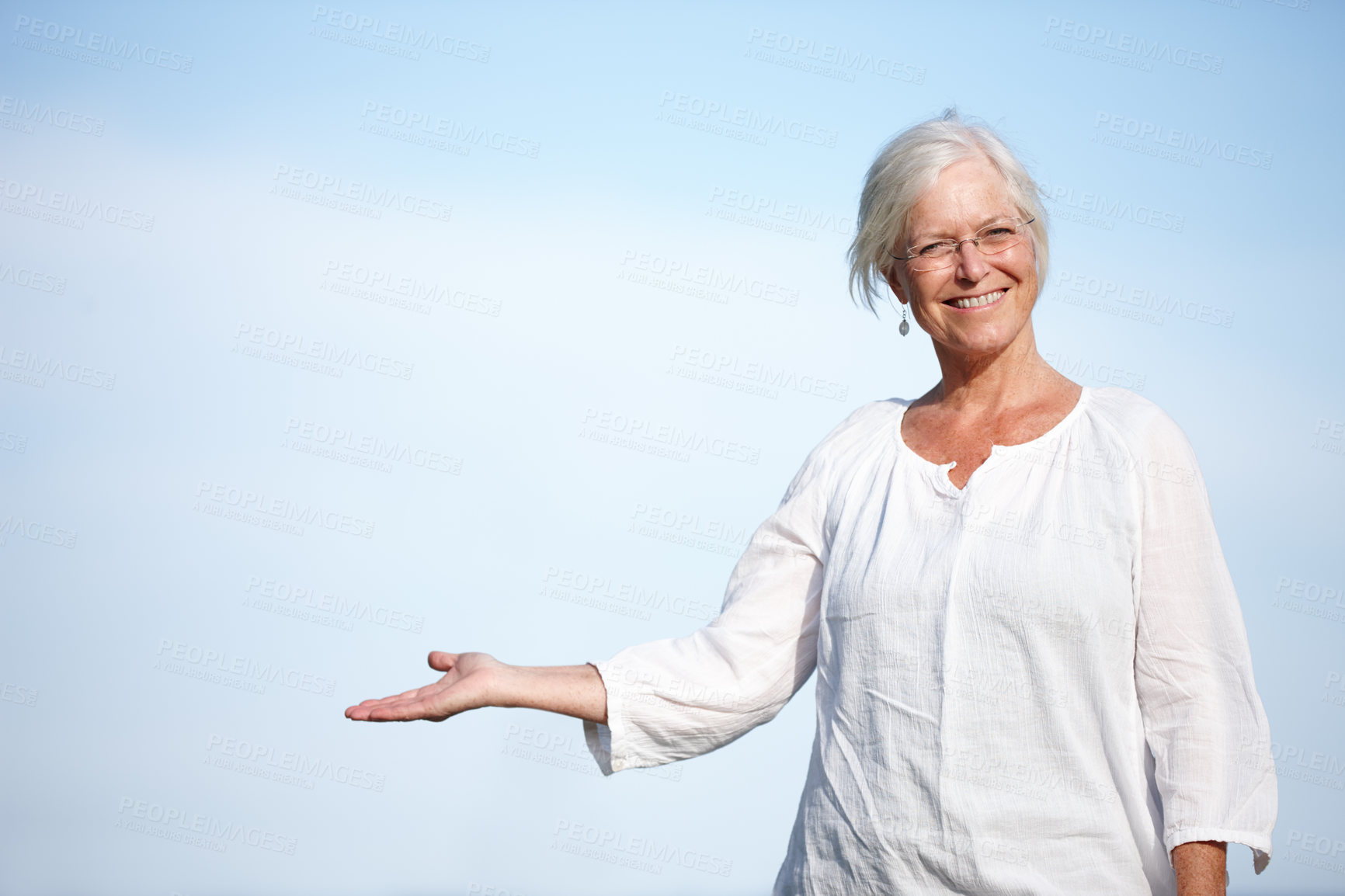 Buy stock photo Senior, woman and portrait with advertisement for presentation on blue sky mockup space. Mature, person and show product placement for promotion, information or happy with retirement plan opportunity