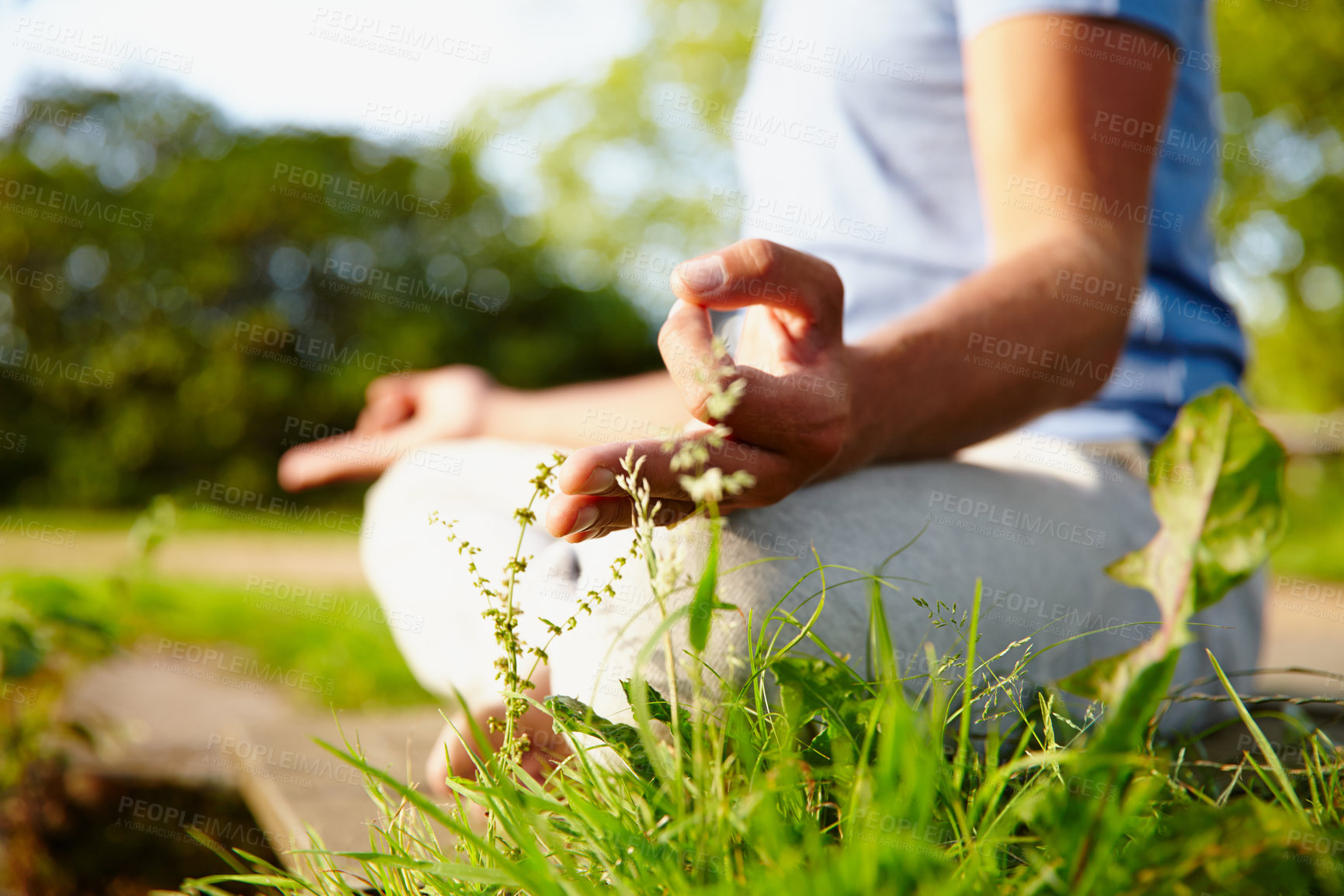 Buy stock photo Closeup of one man meditating in harmony with om finger gesture practising yoga on grass outdoors with copyspace. Calm and relaxed guy feeling zen praying quietly for stress relief and peace of mind 