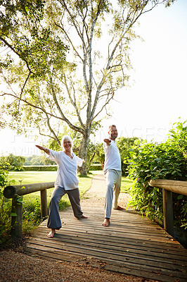 Buy stock photo Couple, stretching and happy with yoga in park for exercise, balance and mobility in nature. Bridge, mature people and warrior pose for arm workout, holistic wellness or training with pilates outdoor