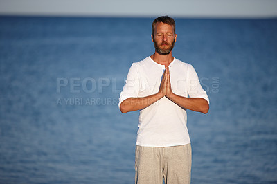 Buy stock photo Mature, man and meditation with yoga at ocean for mindfulness healing, spiritual peace and performance. Male person, zen and water with chakra zen for mental health, mindset balance and nature aura