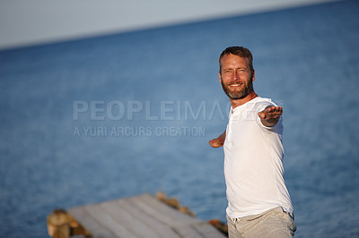 Buy stock photo Ocean, man and stretching on portrait for fitness, yoga and exercise in German. Male person, outdoor and smile or satisfied for retirement on break with self care, wellness or health with arms open