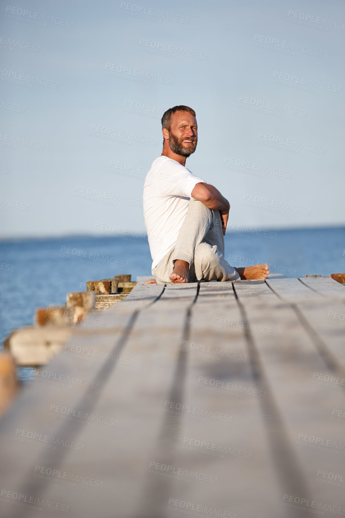 Buy stock photo Man, stretching and yoga at sea with space, calm or peace for spiritual healing. Mature fitness person, Lord of the Fishes or pilates on ocean dock for wellness, exercise or healthy posture in nature