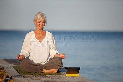 Buy stock photo Mature, happy woman and meditation with tablet by lake for online tutorial, lesson or virtual class in nature. Senior, female person or yogi with smile for holistic training, inner peace or exercise