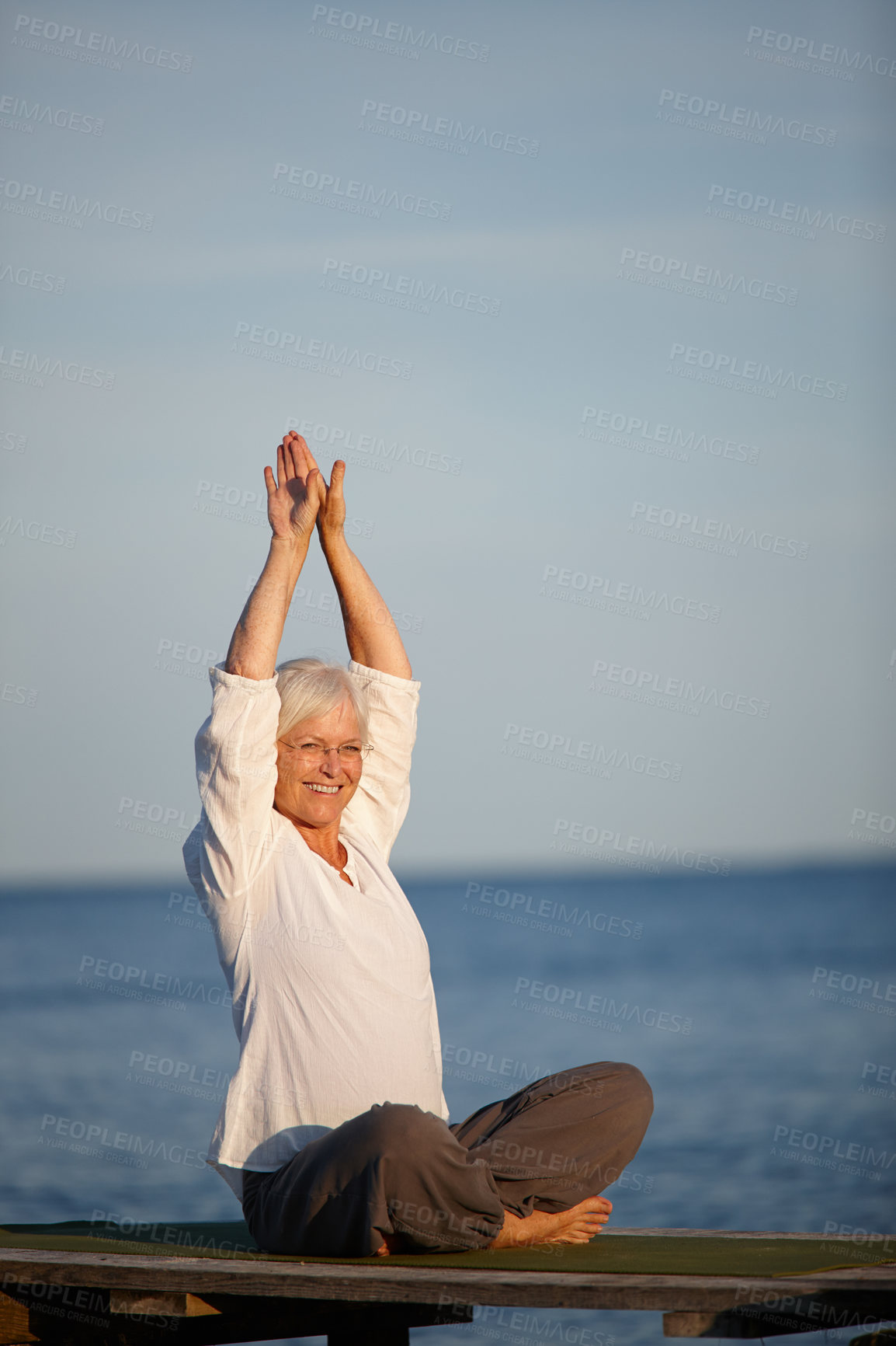 Buy stock photo Mature woman, portrait or yoga with meditation by lake for exercise, workout or holistic balance in nature. Senior, female person or yogi with smile for training, health or wellness by beach or ocean