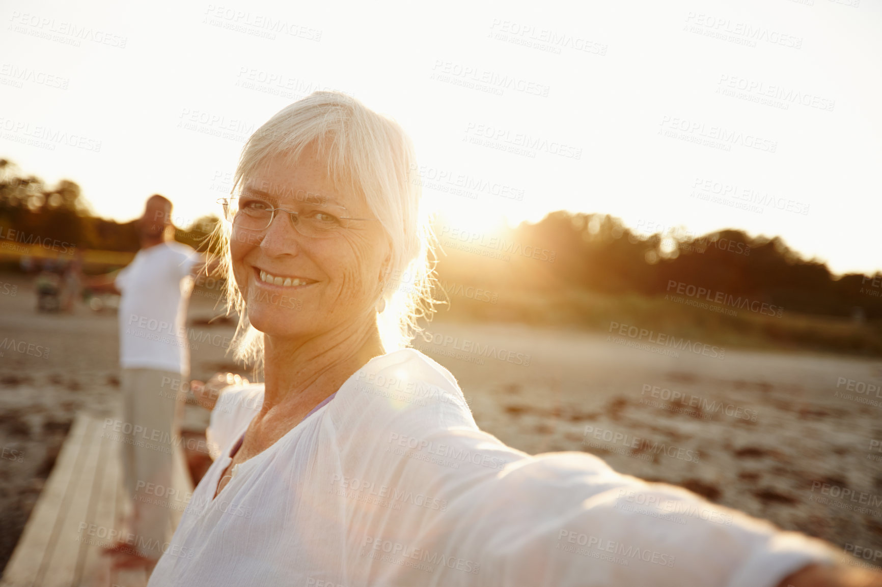 Buy stock photo Portrait, woman and stretching for yoga on beach with partner, holistic healing and spiritual wellness. Smile, mature person and warm up with pilates, mindfulness and performance for fitness outdoor